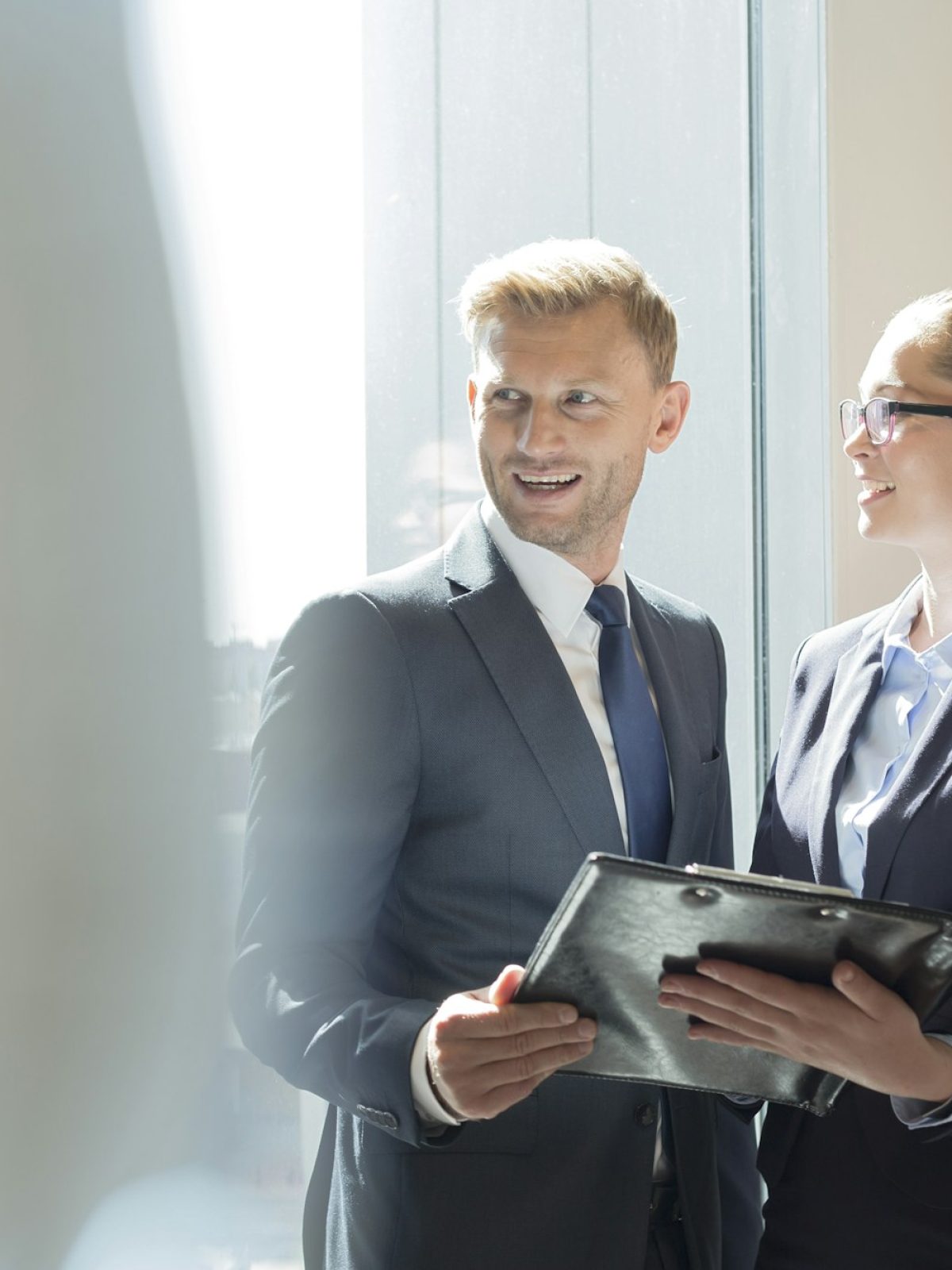 Businessman and businesswoman preparing for meeting